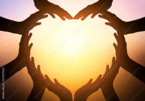 International Day of Friendship concept: hands in shape of heart on blurred  background